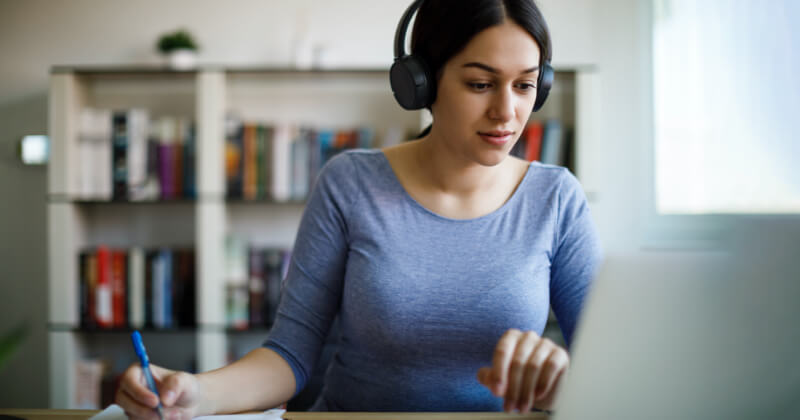 Woman working with headphones on.